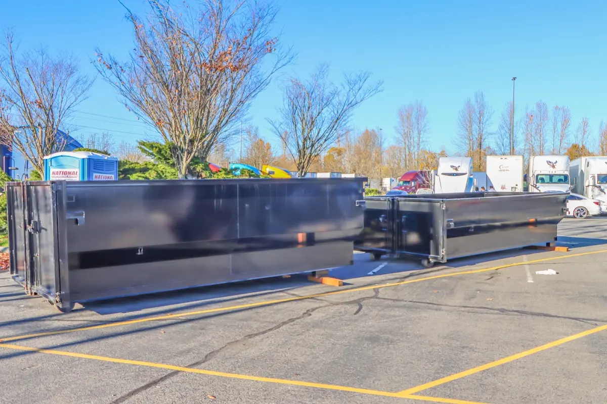 Professional dumpster rental service with roll-off container on residential driveway in Atwater